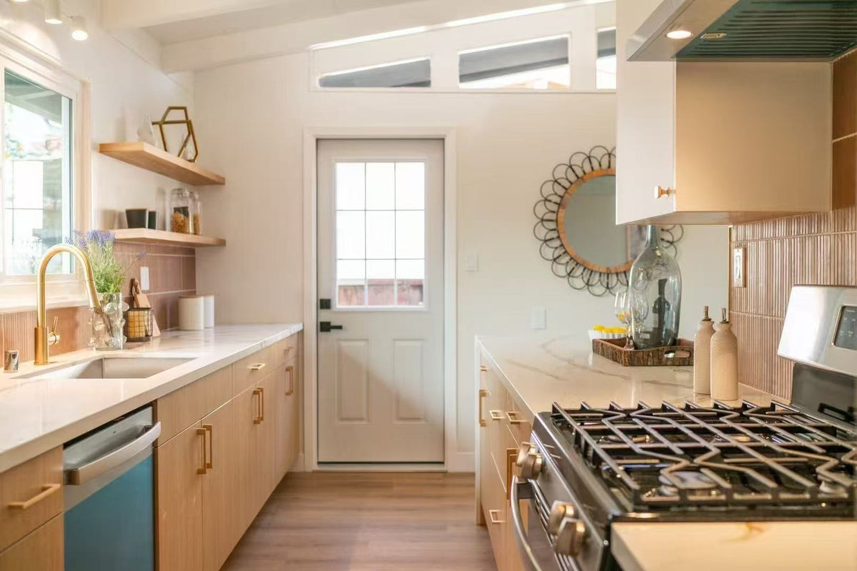 Modern kitchen build-out showcasing full-overlay Modern Oak laminate frameless cabinets with commercial-grade construction.